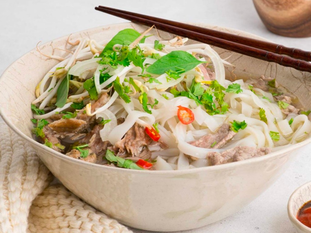 snap dragon pho in a bowl with chopsticks