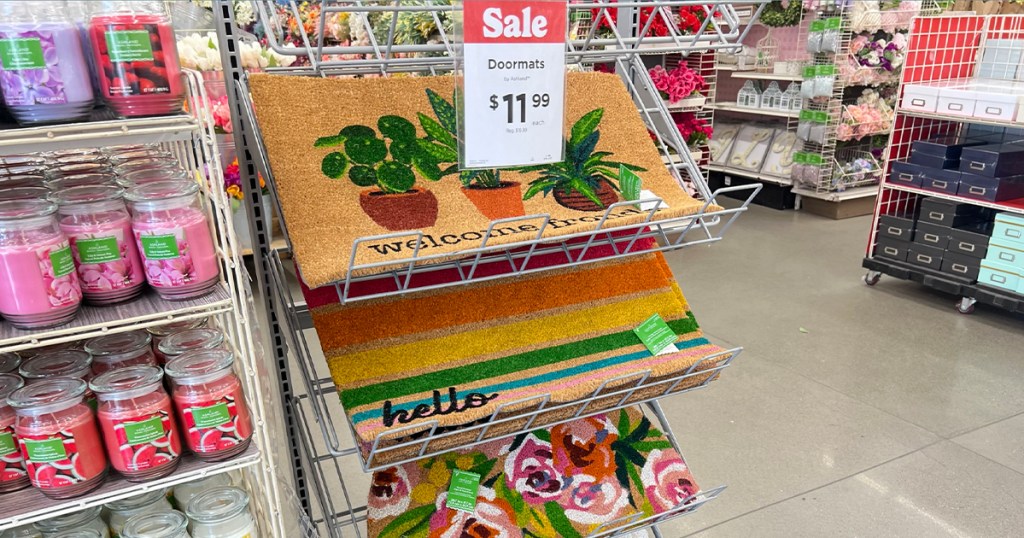 michaels spring doormats on stand with sale sign in store
