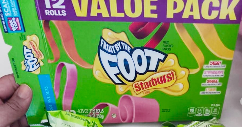 hand holding fruit by the foot starburst box