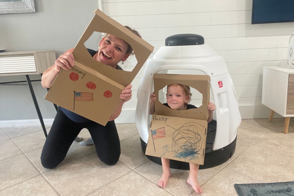 mom and son in cardboard space helmets