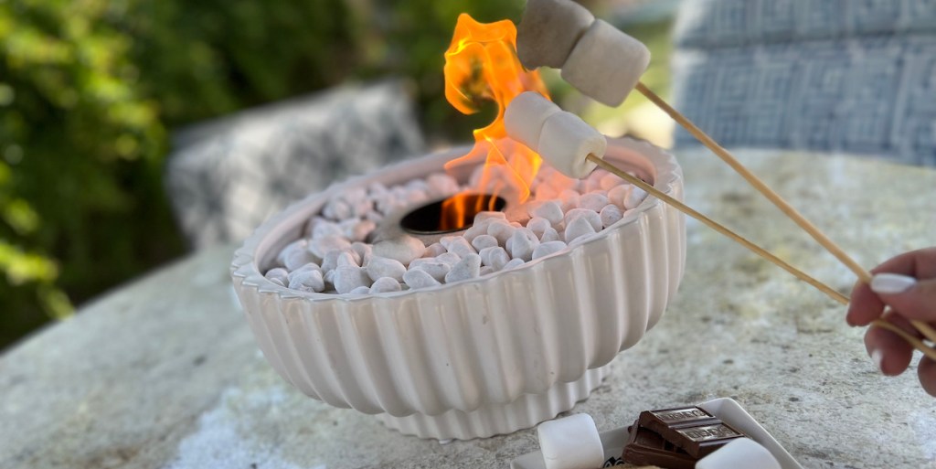 close up of white pleated bowl with tabletop firepit inside