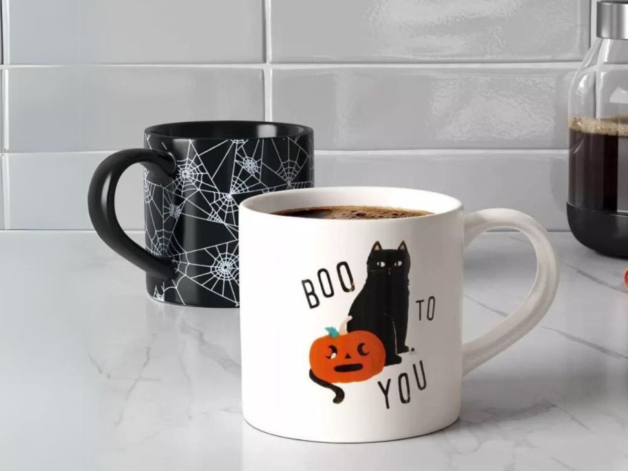 hyde and eek boutique halloween mugs on counter
