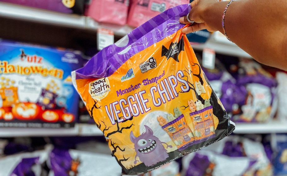 hand holding up bag of halloween treats veggie chips