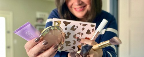 woman holding tarte makeup products