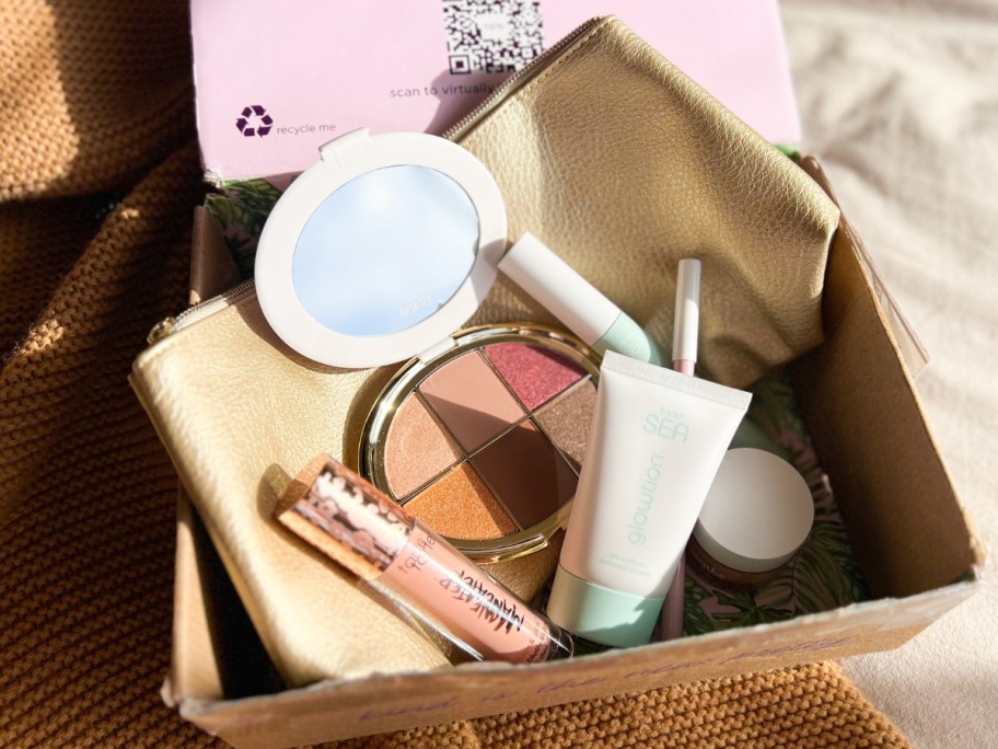box with Tarte cosmetics makeup items and tan color makeup bag