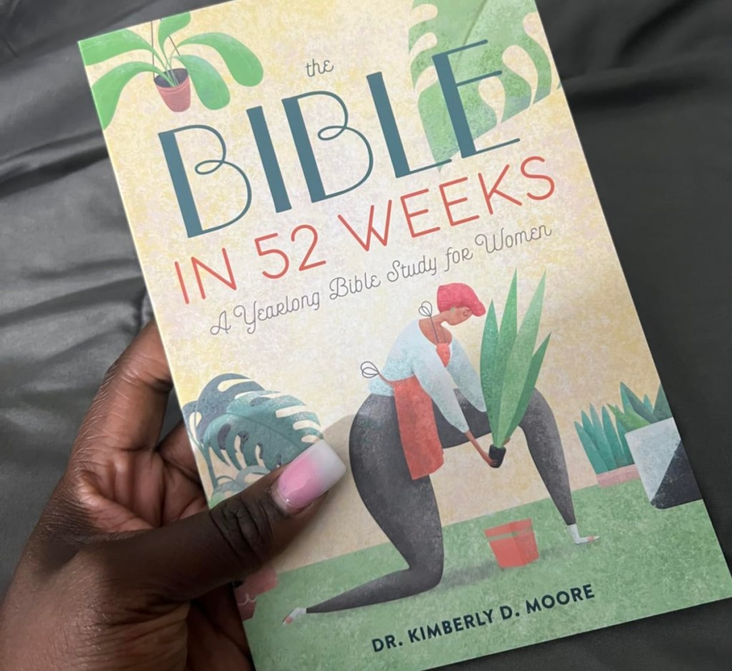 holding a Bible workbook