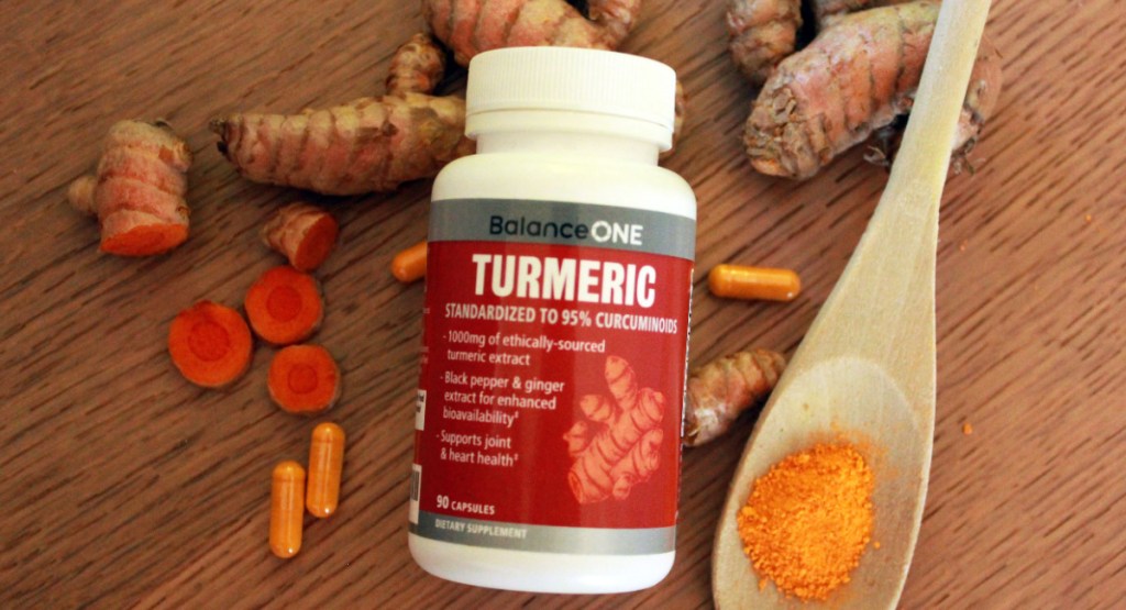 turmeric capsules displayed with ginger