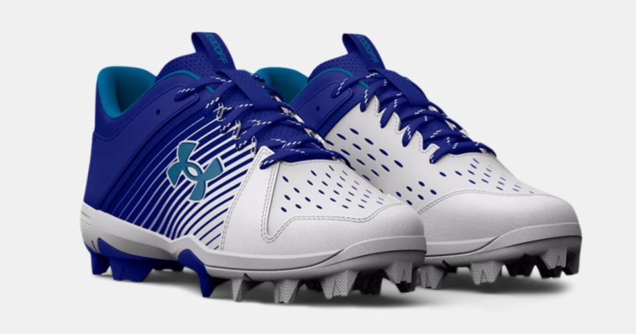 pair of gray and blue under armour baseball cleats