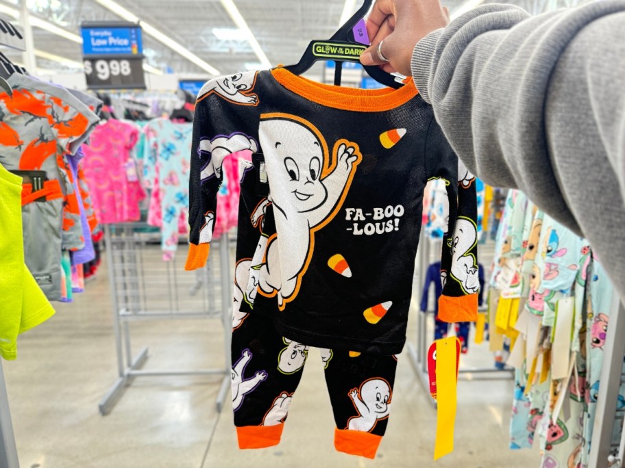 hand holding a set of toddler Casper Halloween pajamas in Walmart
