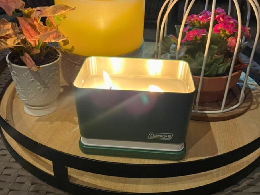 a Coleman Cooler Citronella candle burning