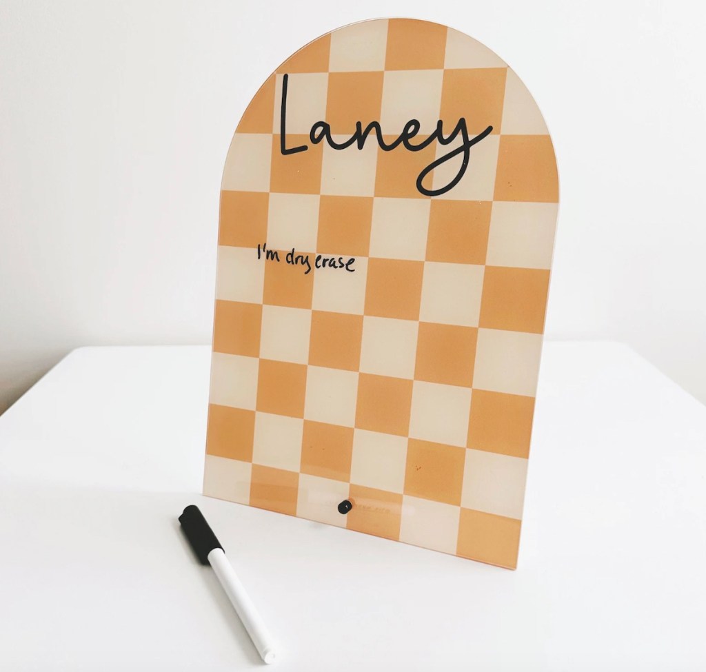 white and yellow plaid dry erase board on white table with marker