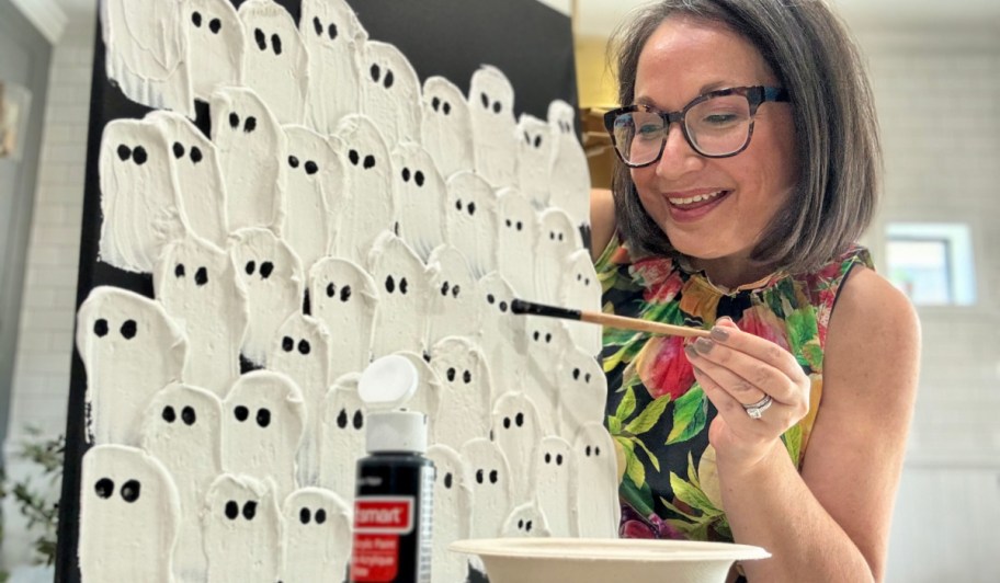 woman adding eyes to ghost plaster canvas (1)