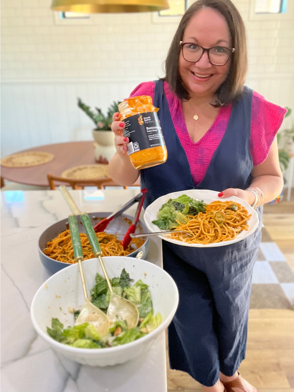 woman cooking with good and gather butternut squash sauce as an easy meal