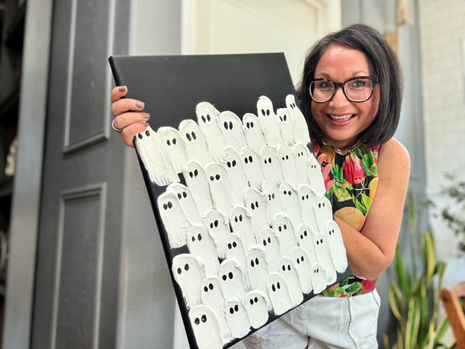 woman holding a diy michaels copycat ghost canvas (1)