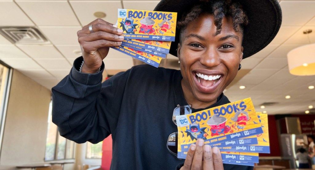 woman holding wendys boo books and tickets