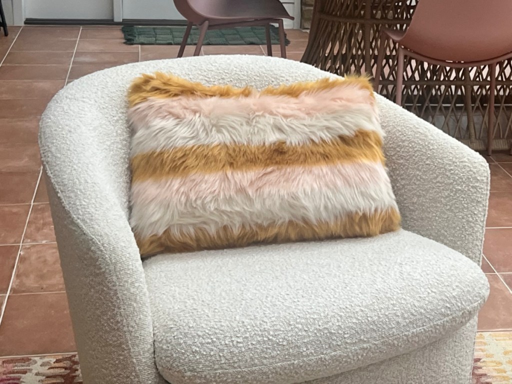 world market throw pillow on chair in Collins home