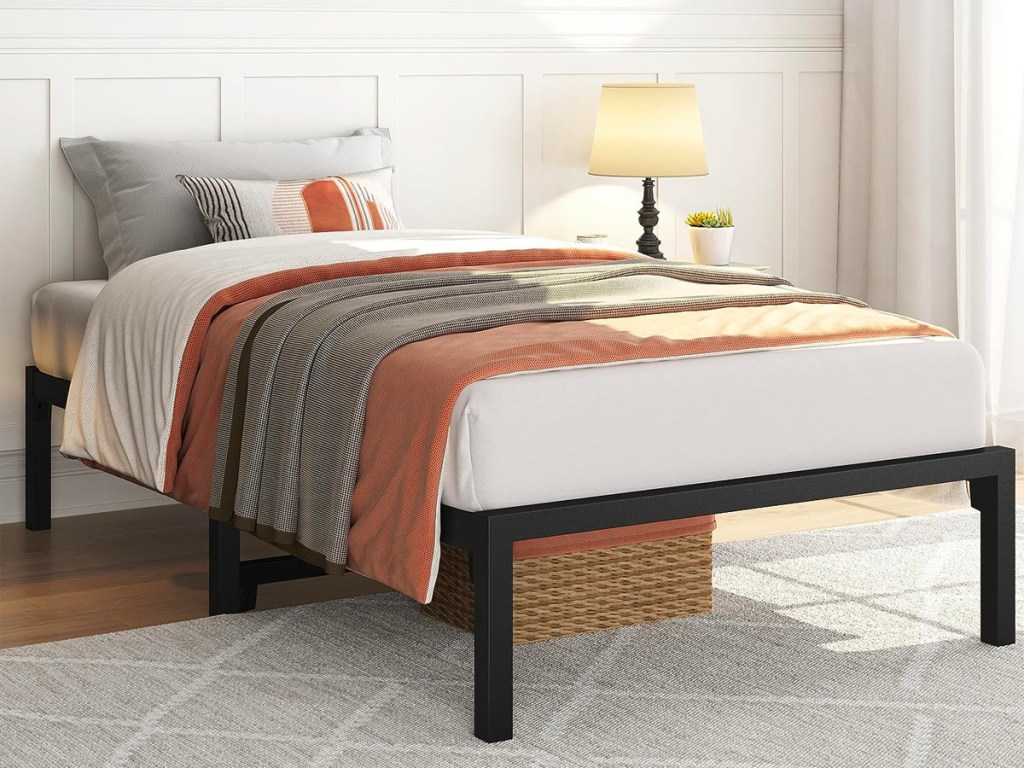 black twin bedframe with bedding 