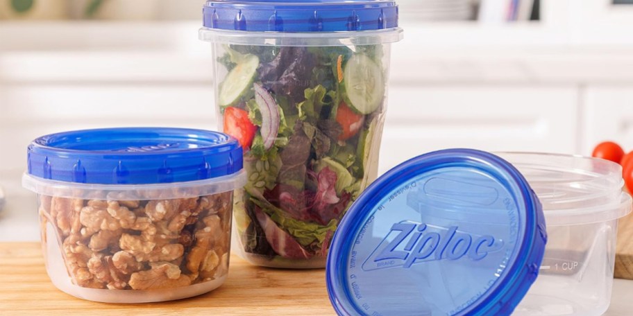 clear containers full of food with blue tops on counter