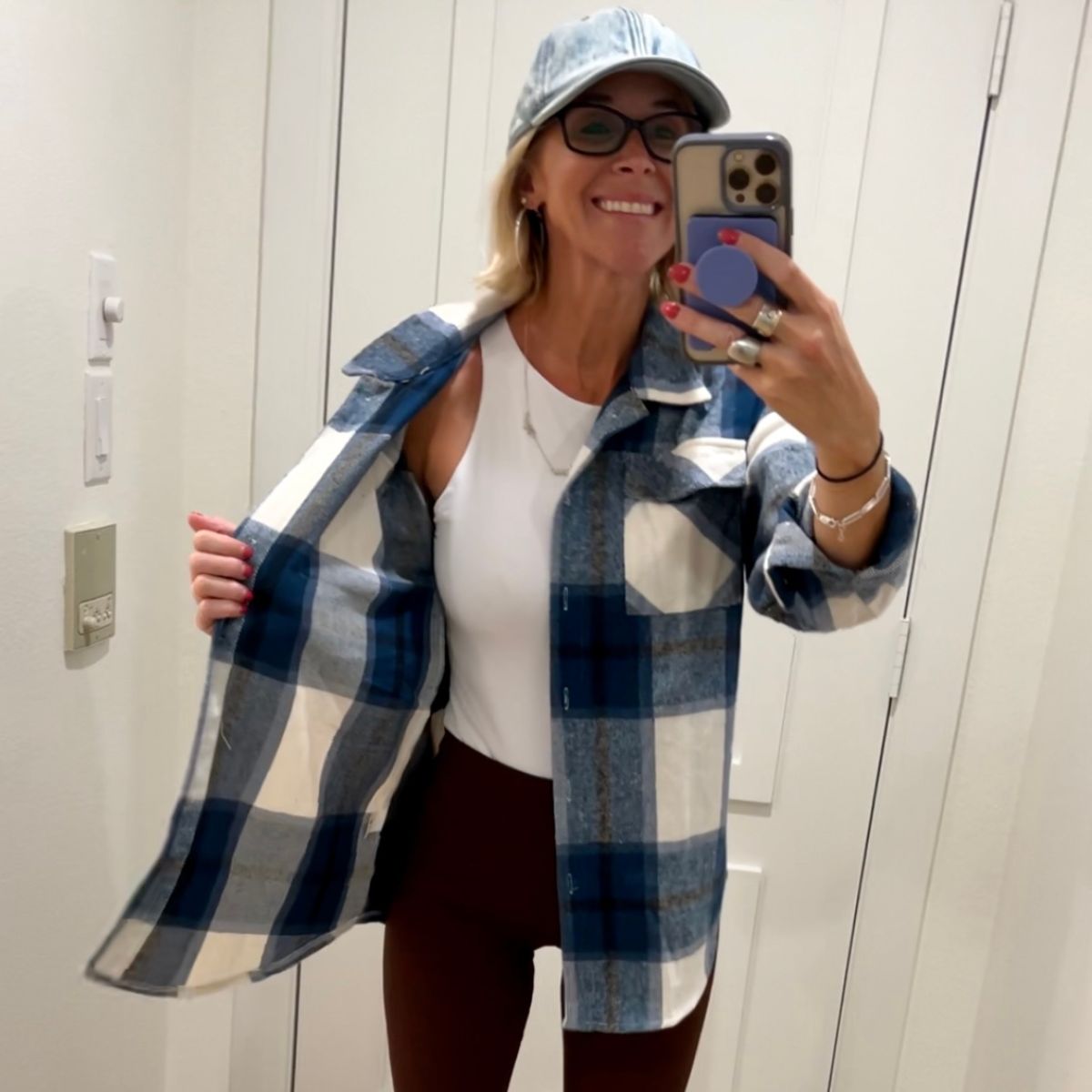 a woman modeling a ATHMILE Women’s Casual Plaid Shacket in dark blue and white plaid