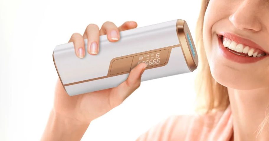 woman holding Aopvui Laser Hair Removal Device near face