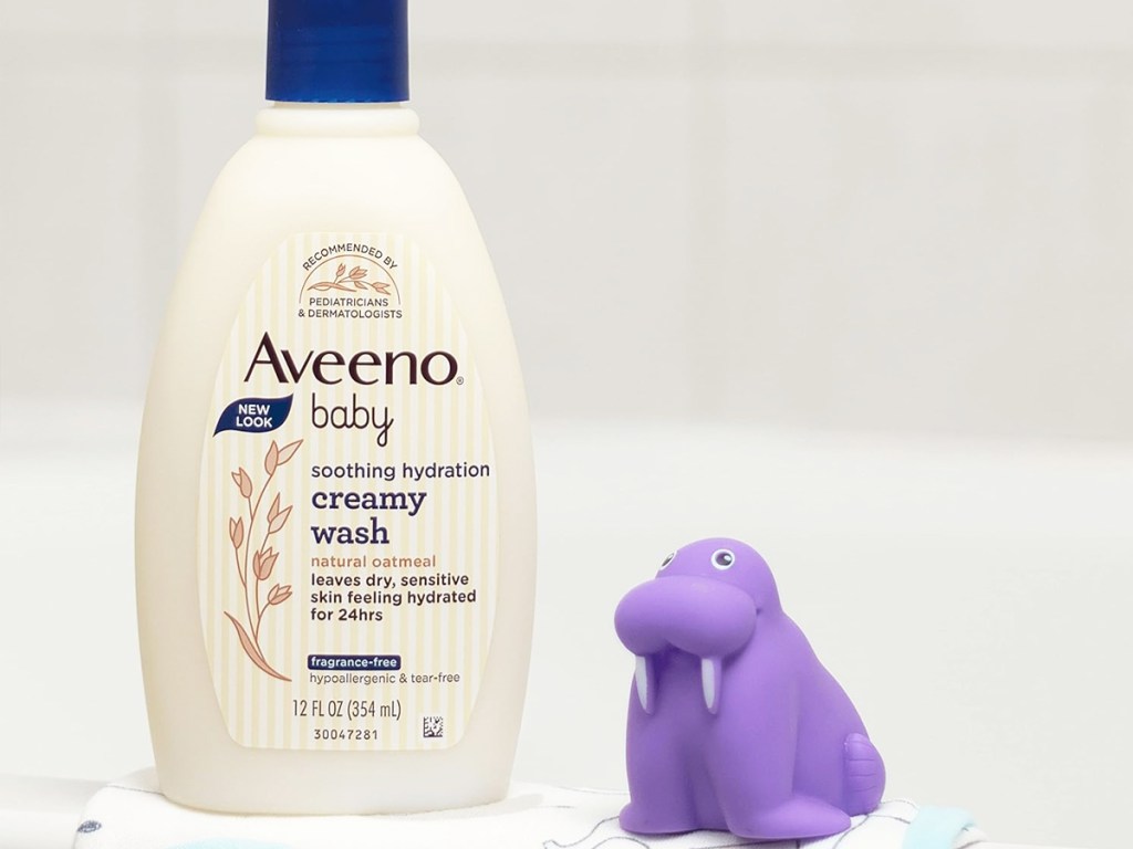 bottle of Aveeno Baby Soothing Hydration Creamy Body Wash on edge of tub with bath toy