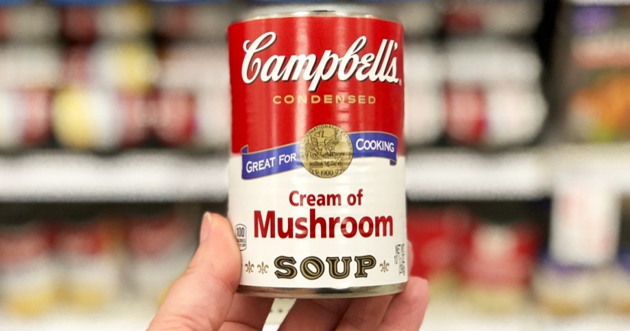 hand holding a can of Campbell's Condensed Cream of Mushroom Soup