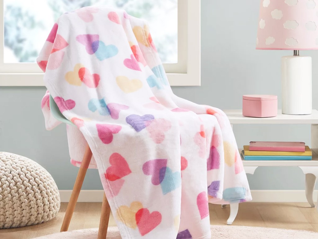 heart print throw blanket draped over chair