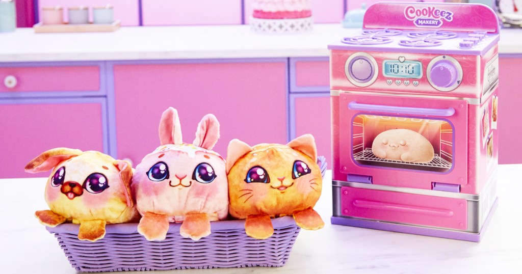 three plush animals in a basket next to a Cookeez Makery Oven