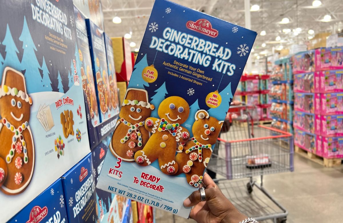 person grabbing Gingerbread kit from store shelf