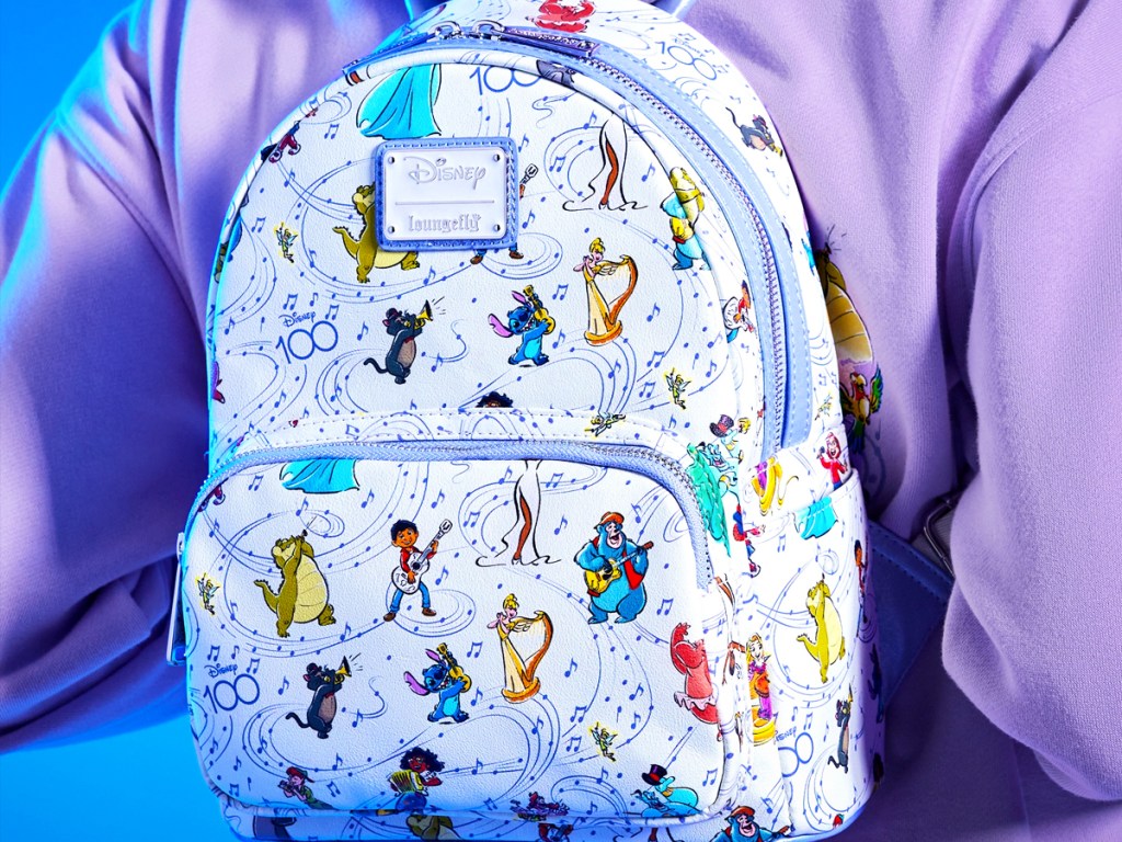 woman wearing loungefly backpack with musical disney character print