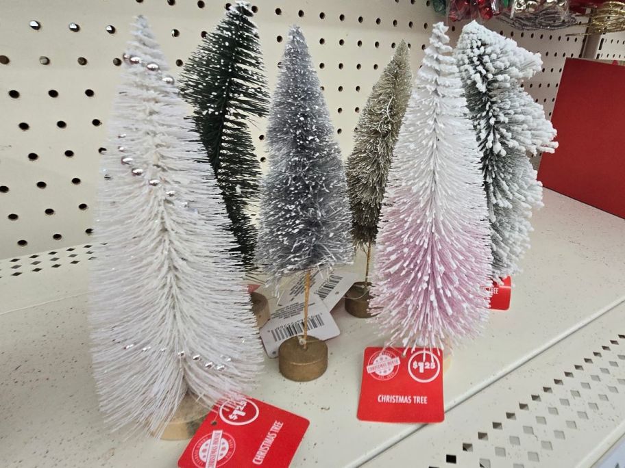 A shelf of various Bottle Brush trees from Dollar Tree