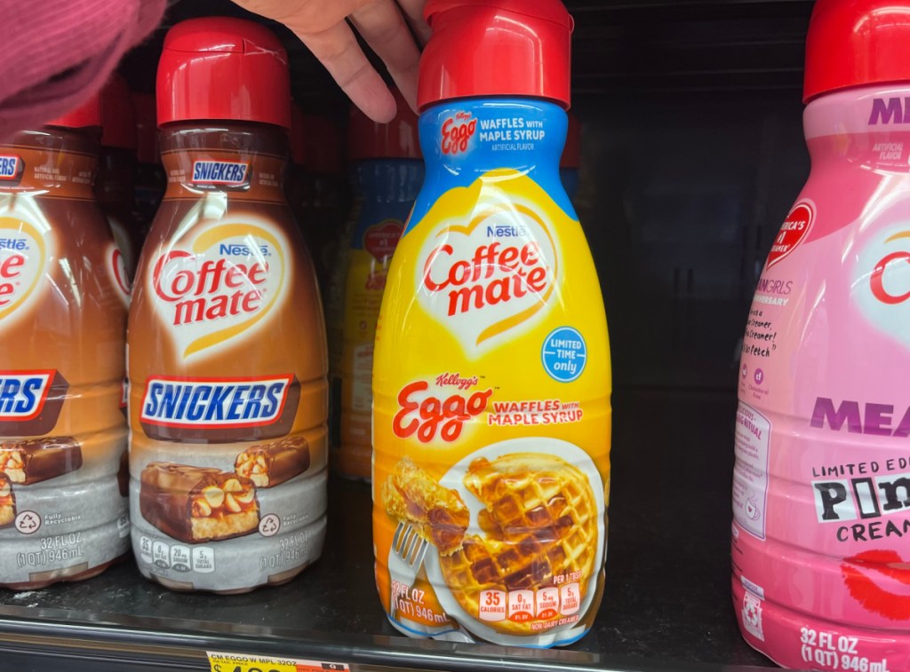 Hand holding a bottle of Eggo Waffles and Maple Syrup Coffee Mate Creamer