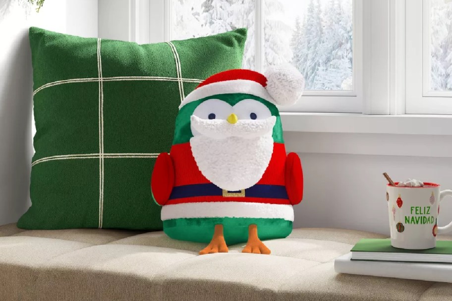 Featherly Friends Bird Dressed as Santa Christmas Throw Pillow on a window seat