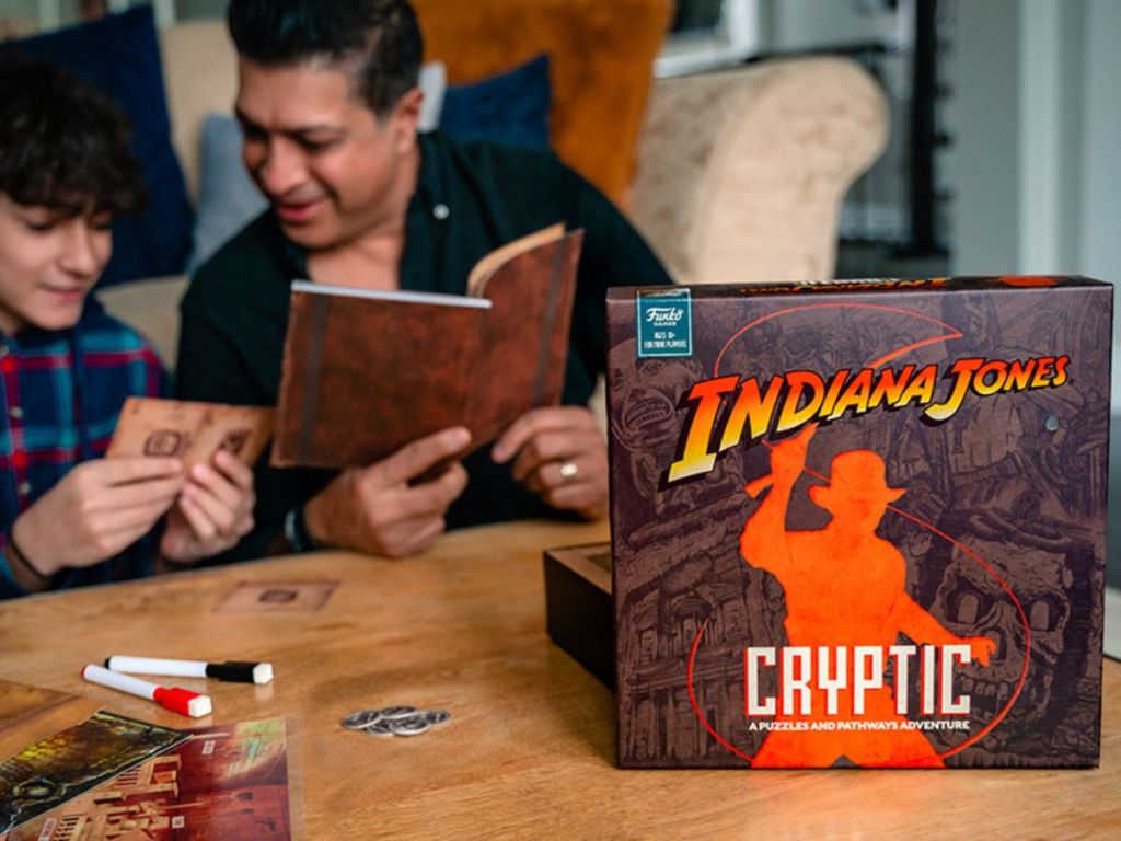 Father and son playing Funko Indiana Jones Cryptic Game