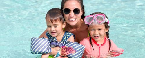 Woman with her two kids at a pool