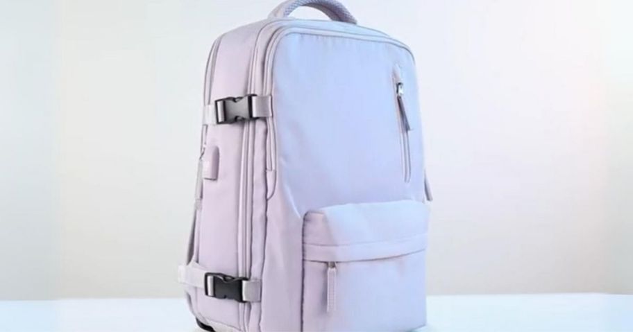 light purple travel backpack standing on counter