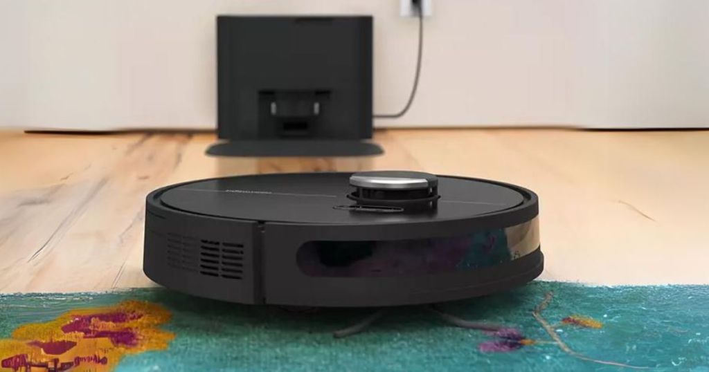 black bObsweep Dustin Robotic Vacuum going over a green rug