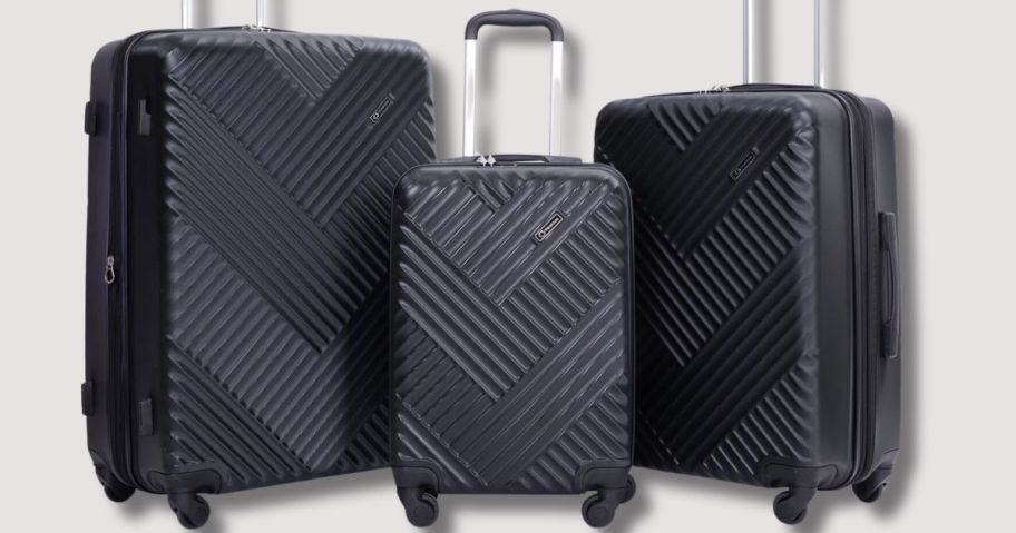 3 pc set of black hard sided spinner wheel luggage with handles up