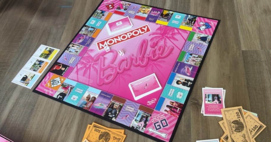 a Barbie Monopoly board game on the floor