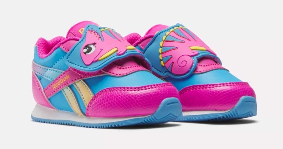 pink and blue Reebok kid's shoes with a chameleon on them