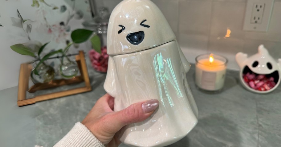 hand holding a ghost candy jar