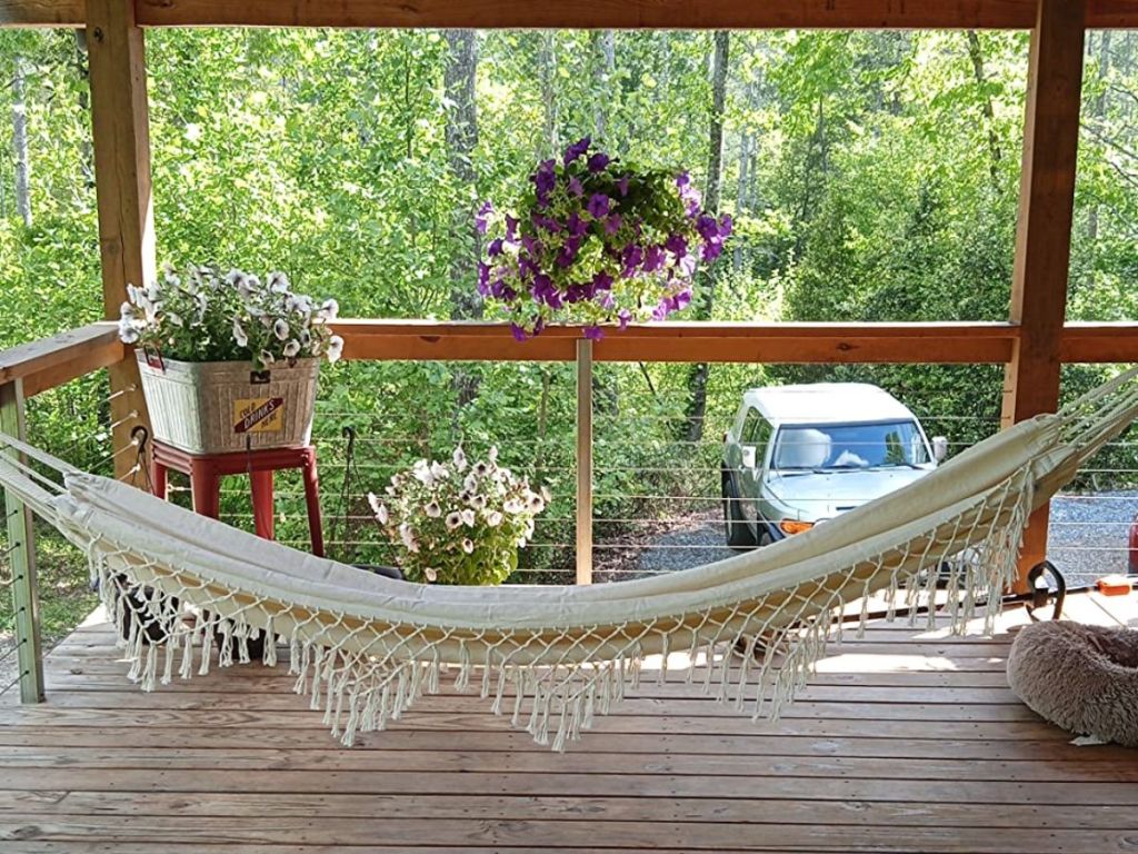 natural color hammock with fringe on a back porch