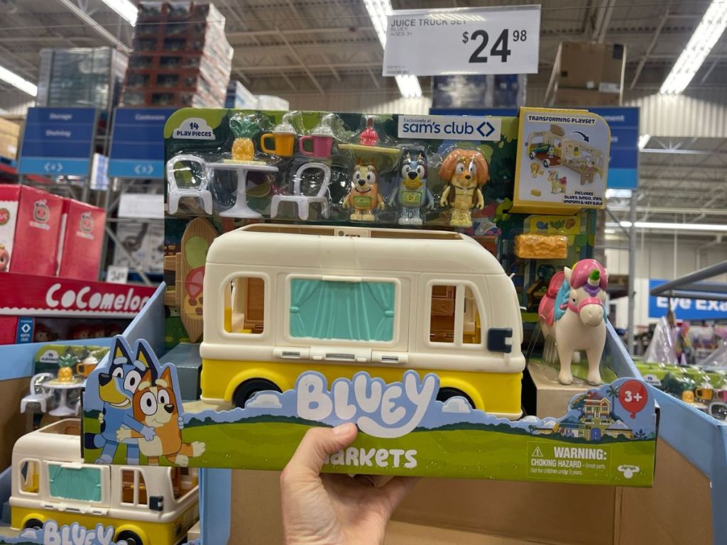 Hand holding a Bluey Juice Truck Playset