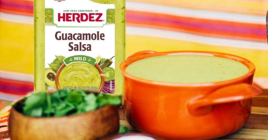 Herdez Guacamole Salsa near bowl of salsa and cilantro