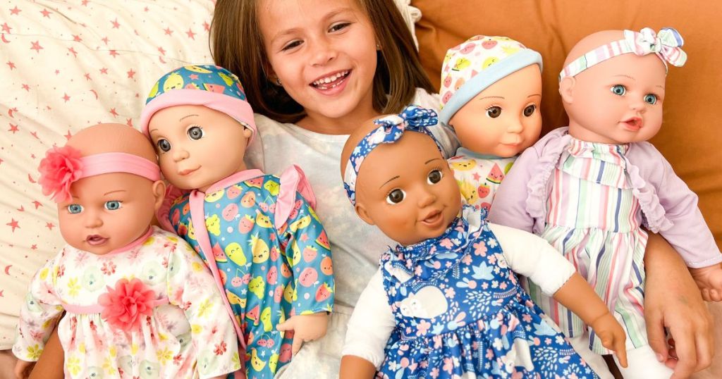 Little girl playing with different Kookamunga Kids Dolls