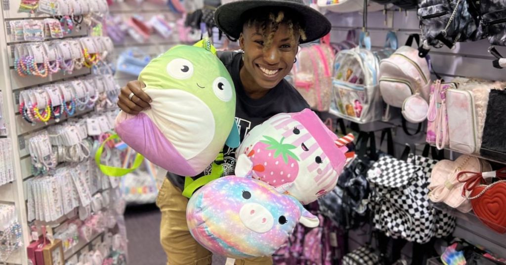 Cam holding Squishmallows at a Claire's Store