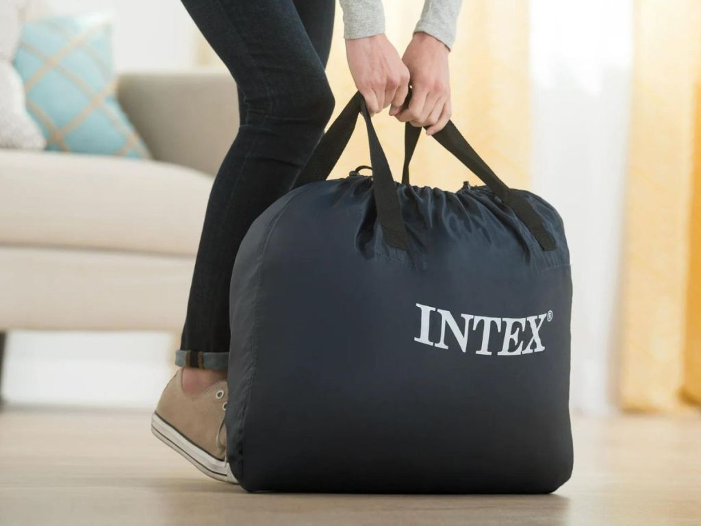A person carrying an Intex Mattress Bag