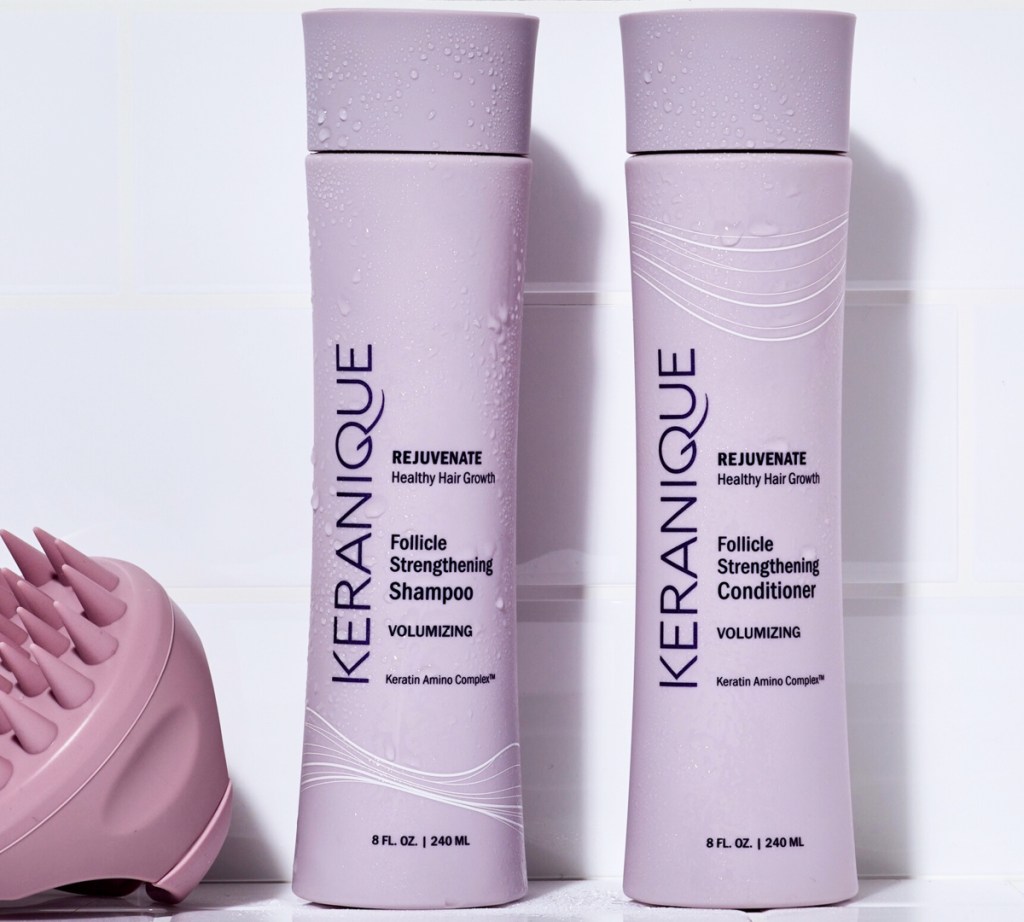 two purple Keranique Shampoo & Conditioner bottles