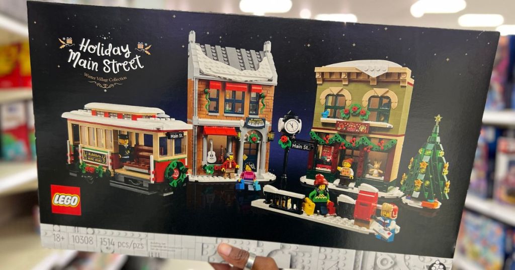Hand holding up a Lego Holiday Main St Building Kit