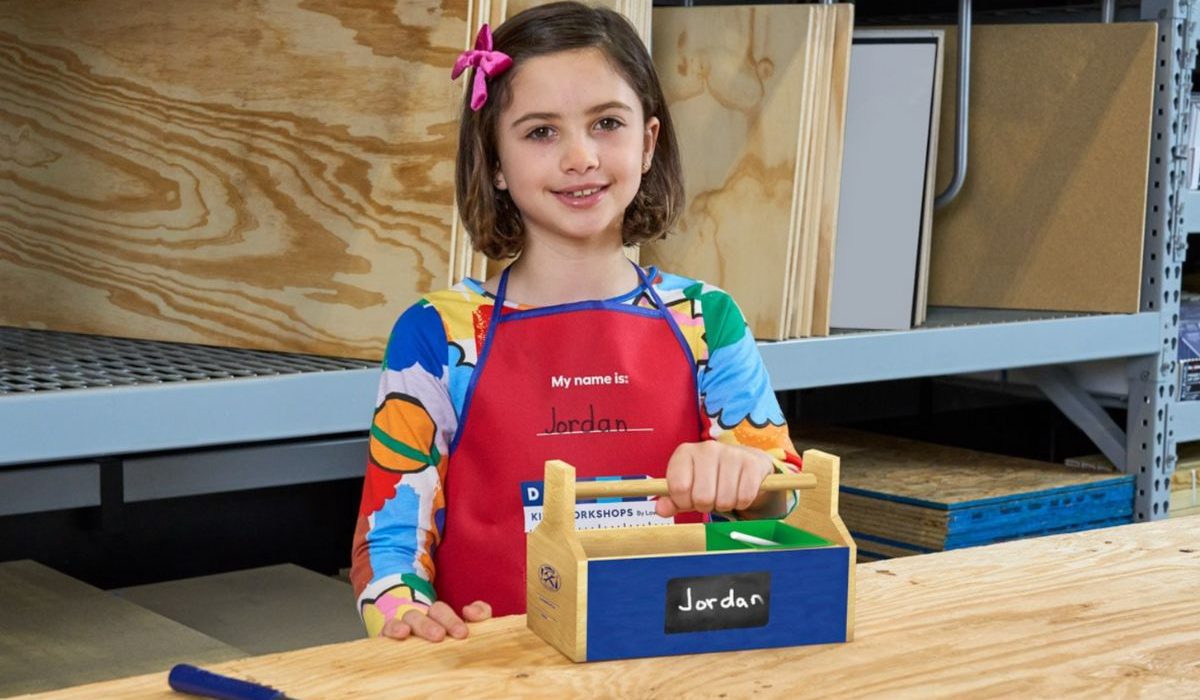 a liittle girl with a Lowes kids diy tool box